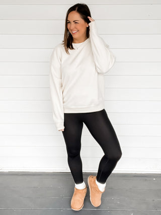 Cassie Cozy Oversized Ivory Sweatshirt with black leggings and white background